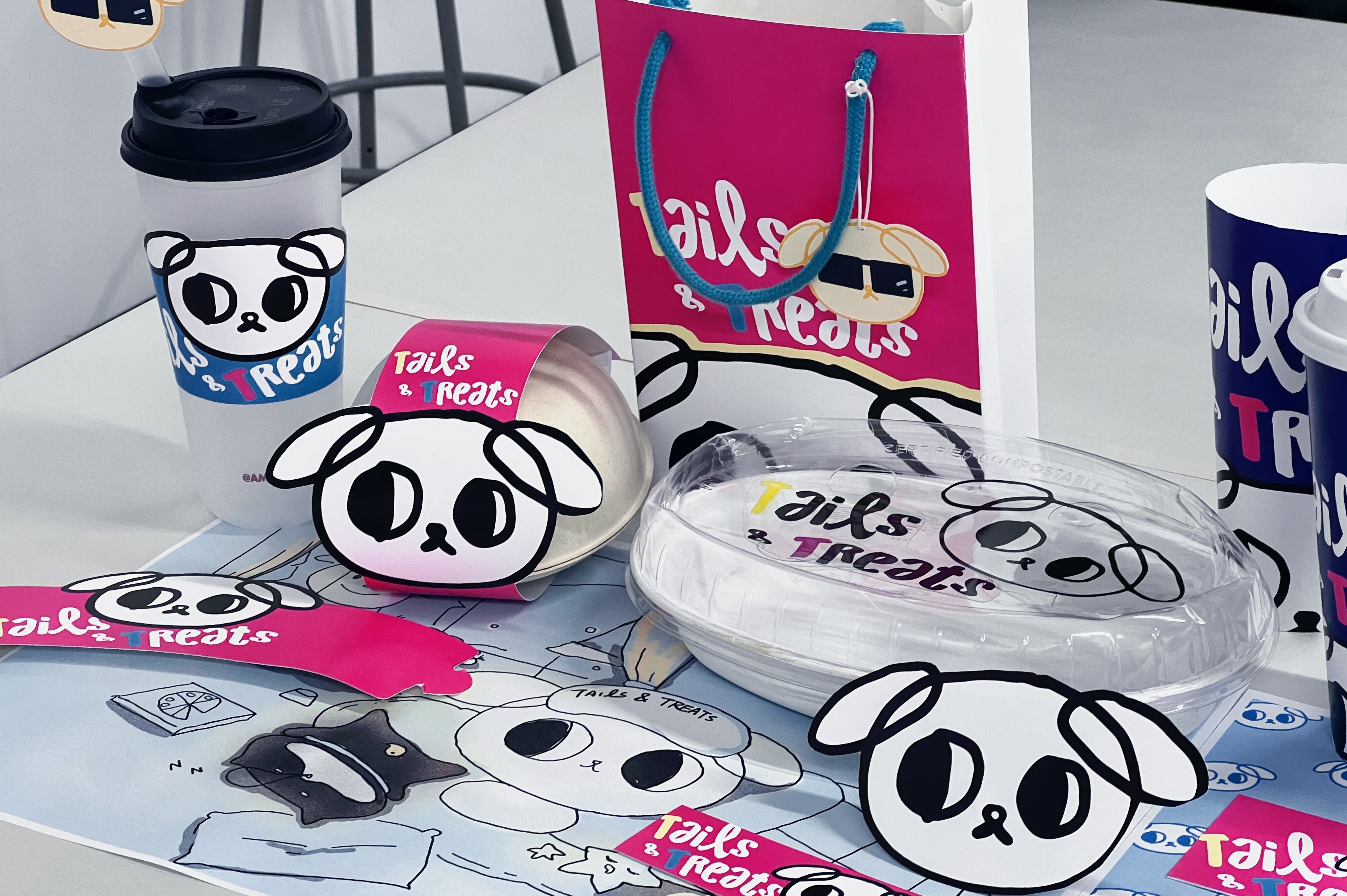 Tails and Treats final branded table setup with cups and packaging